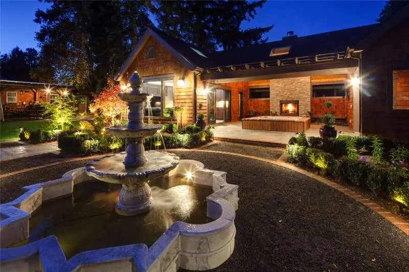 Backyard cabana and pool addition lit at dusk