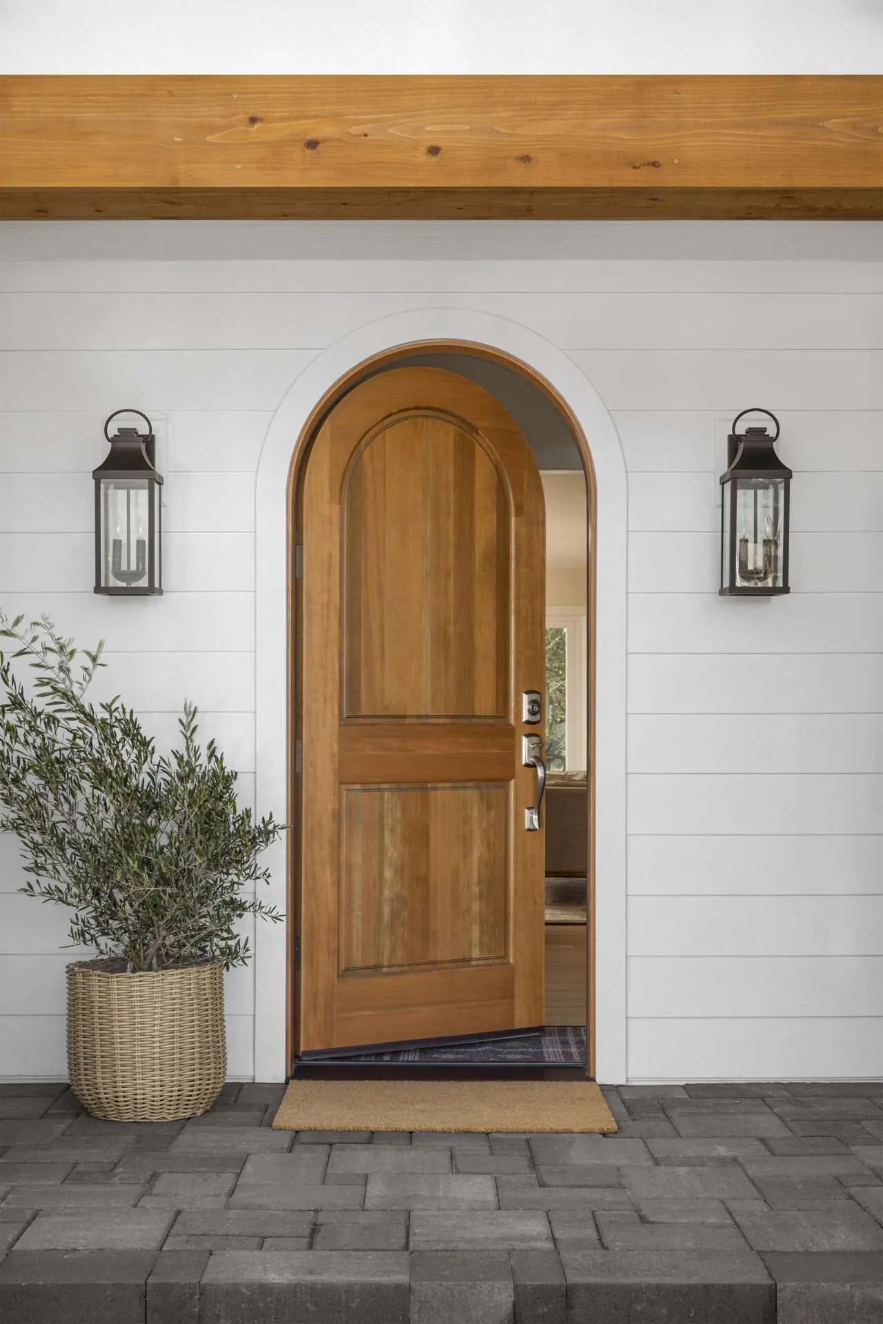 Arched wood entry door in a remodeled home