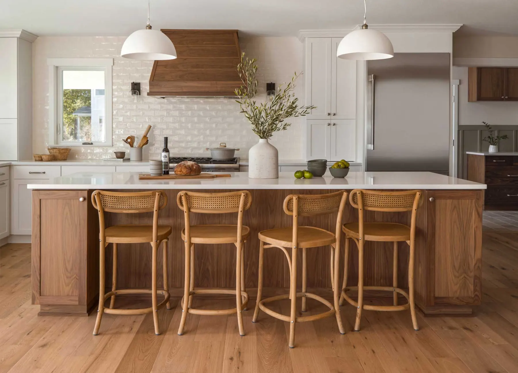 Newberg kitchen remodel with a walnut island, rattan stools and a white tile range wall