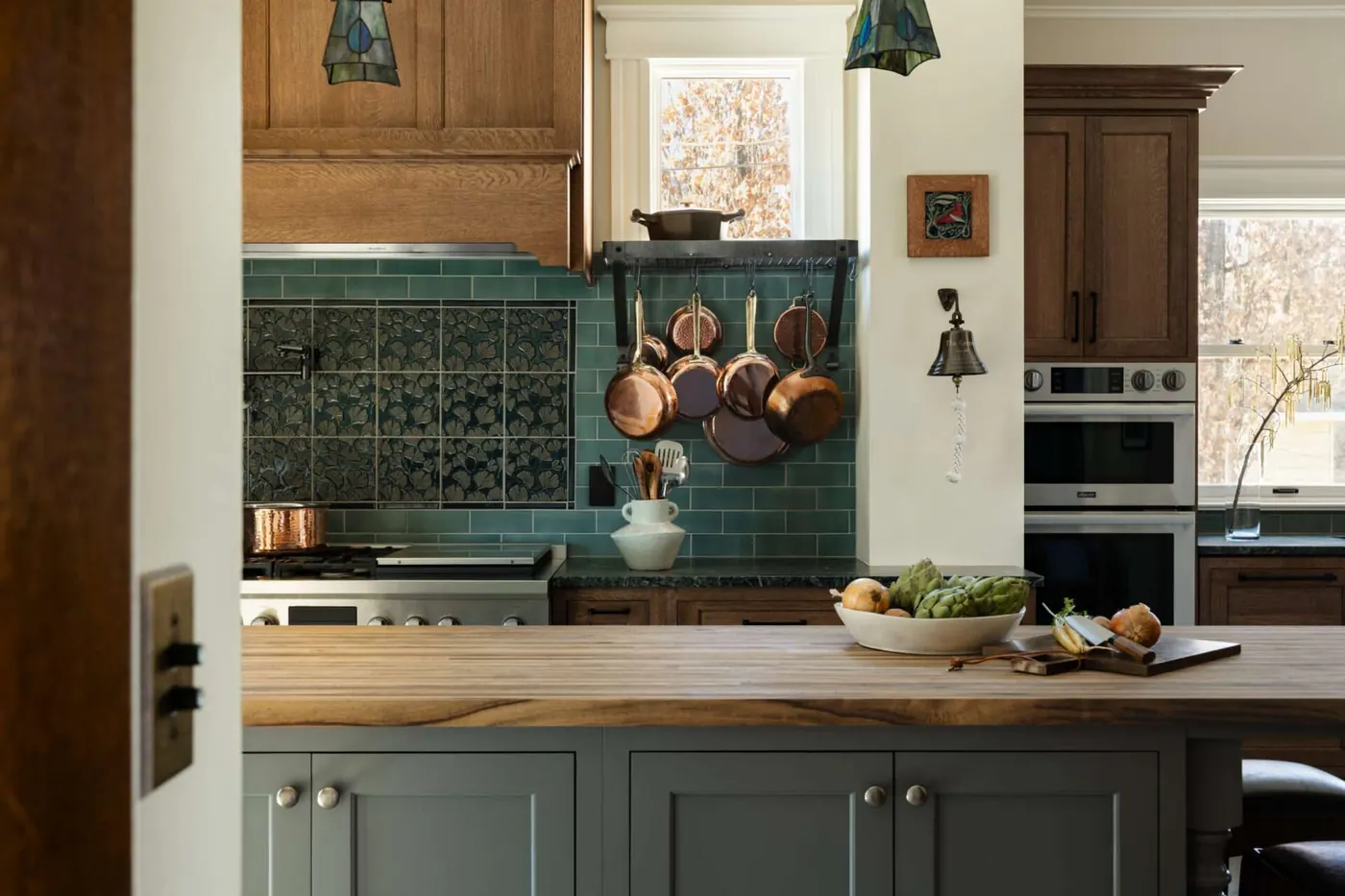 Kitchen with green tile backsplash and wood cabinets in a 1909 McMinnville home