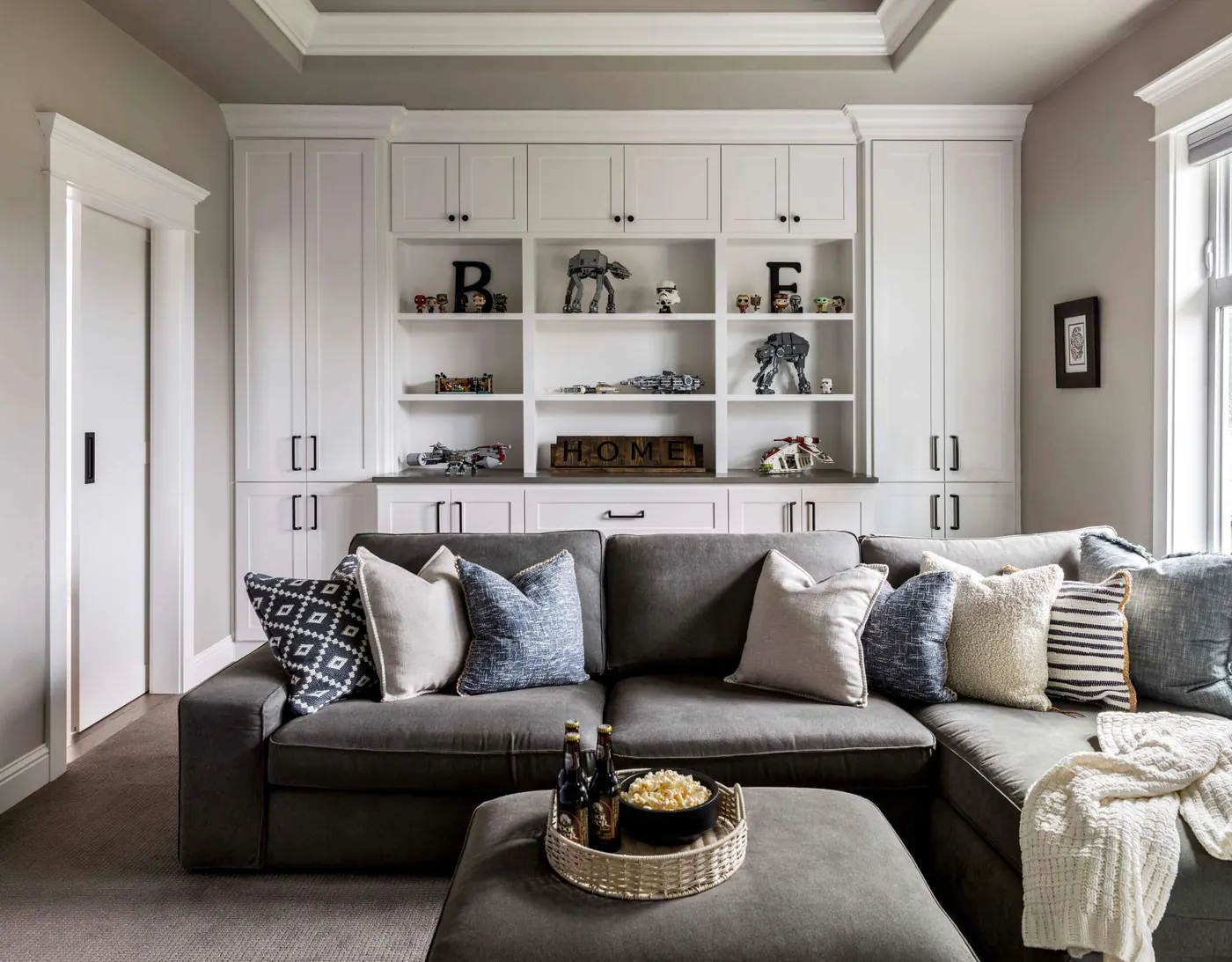 Remodeled living room with built-in shelving and a sectional